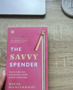 A copy of the Savvy Spender Book held by Megan